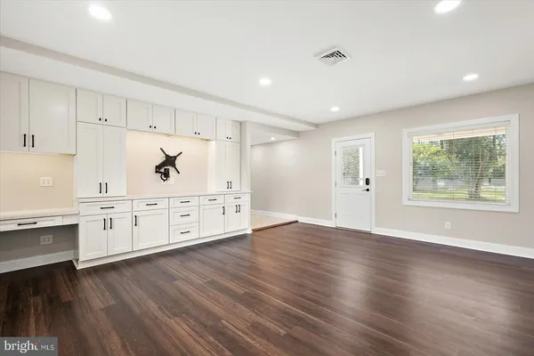 a bathroom with a toilet a sink a mirror a vanity and a shower
