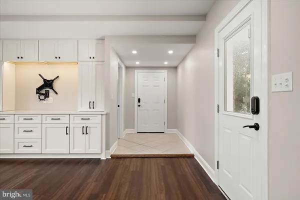 a bathroom with a shower sink vanity mirror and toilet