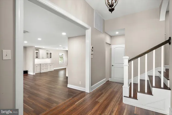 a view of a hallway with wooden floor and windows