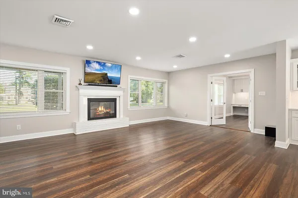 a living room with a fireplace and a flat screen tv