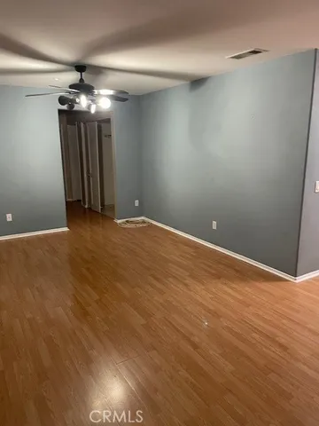 en empty room with an empty space and a ceiling fan