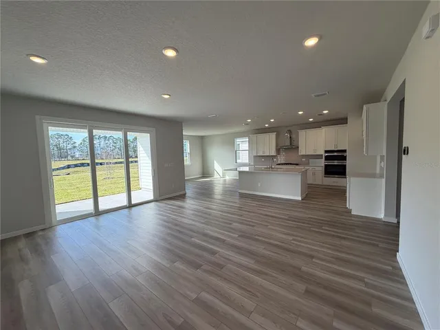 a view of kitchen and a sink with wooden floor
