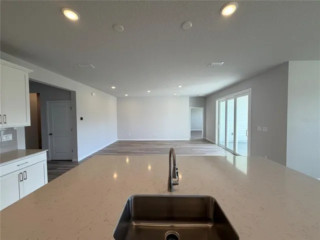 a view of an empty room with window and cabinet