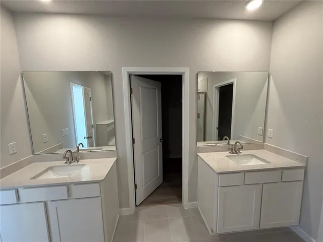 a bathroom with a sink vanity and mirror
