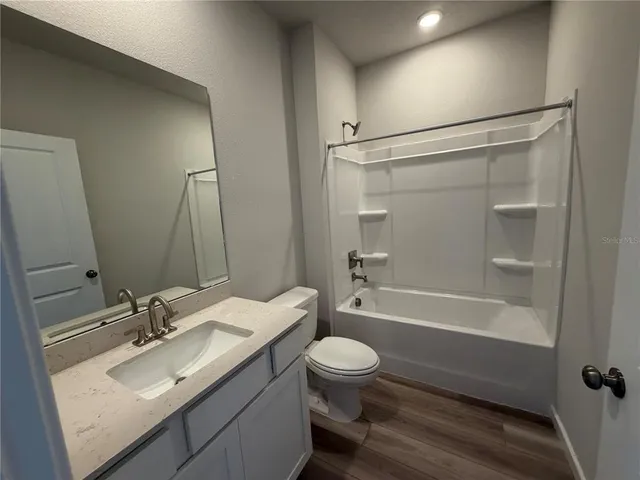 a bathroom with a sink toilet tub and shower