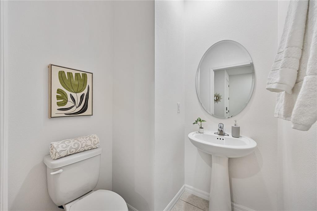 34217 Cinder Way Wesley Chapel, FL 33545 - Photo 13 of 27 a bathroom with a toilet a sink and mirror