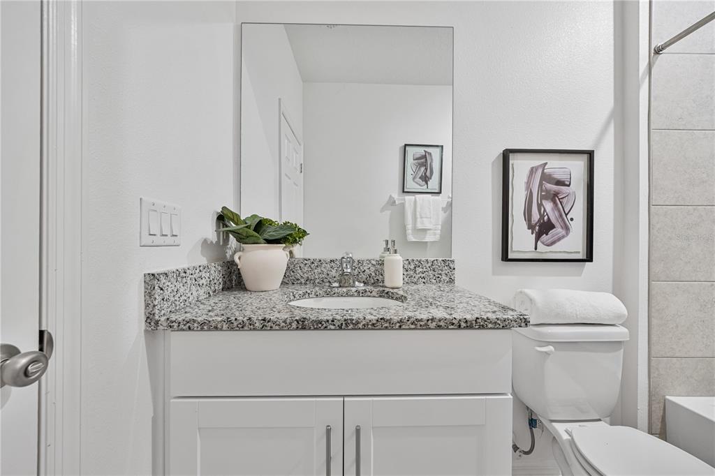 34217 Cinder Way Wesley Chapel, FL 33545 - Photo 17 of 27 a bathroom with a granite countertop sink and a mirror