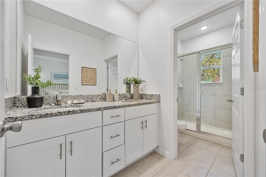 34217 Cinder Way Wesley Chapel, FL 33545 - Photo 21 of 27 a bathroom with a granite countertop sink and a mirror