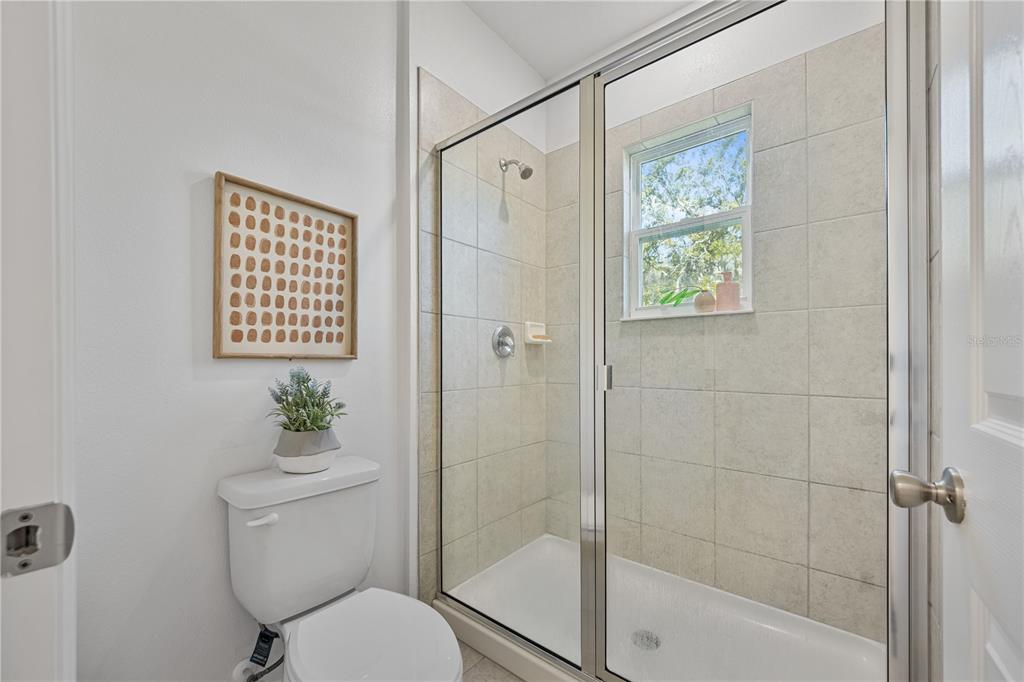 34217 Cinder Way Wesley Chapel, FL 33545 - Photo 23 of 27 a white toilet sitting next to a shower