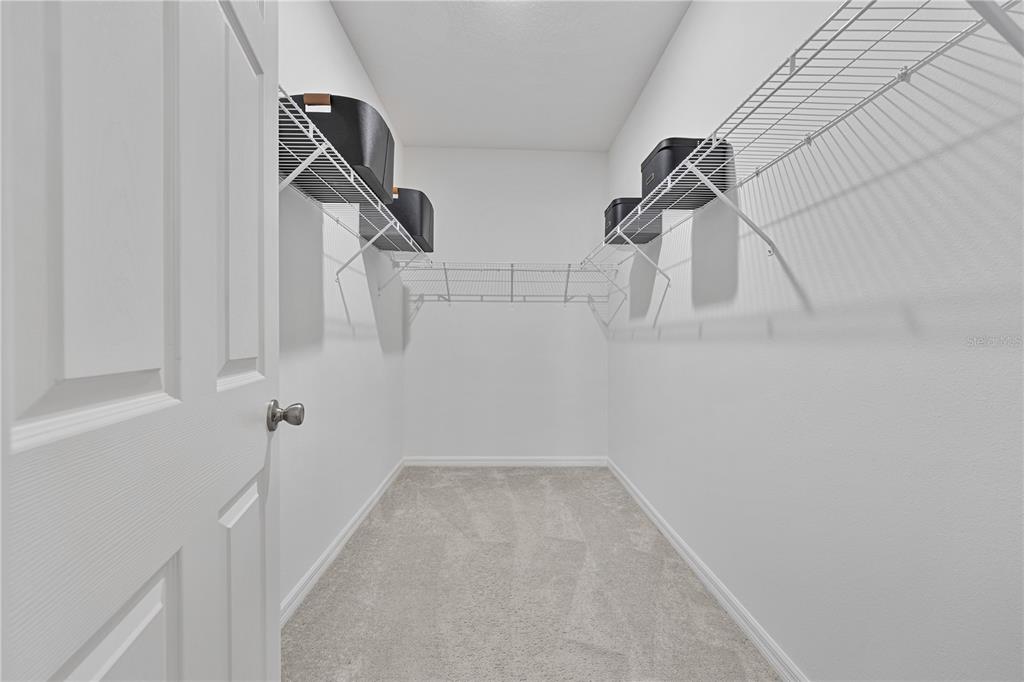 34217 Cinder Way Wesley Chapel, FL 33545 - Photo 24 of 27 a view of small space with racks on the wall