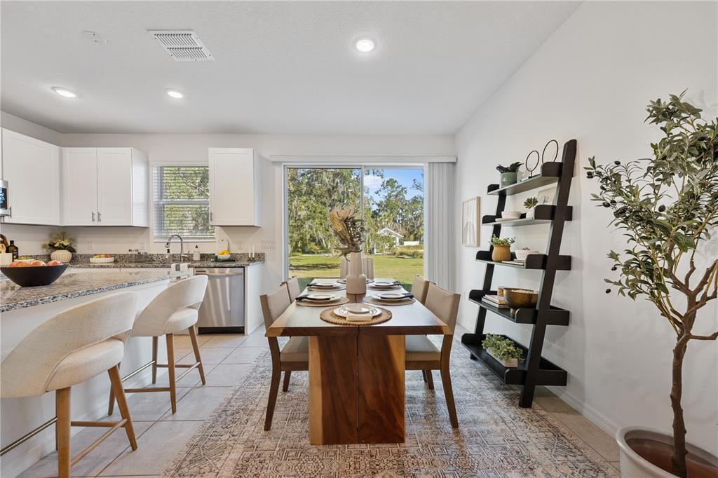 34217 Cinder Way Wesley Chapel, FL 33545 - Photo 8 of 27 a view of a dining room with furniture window and outside view