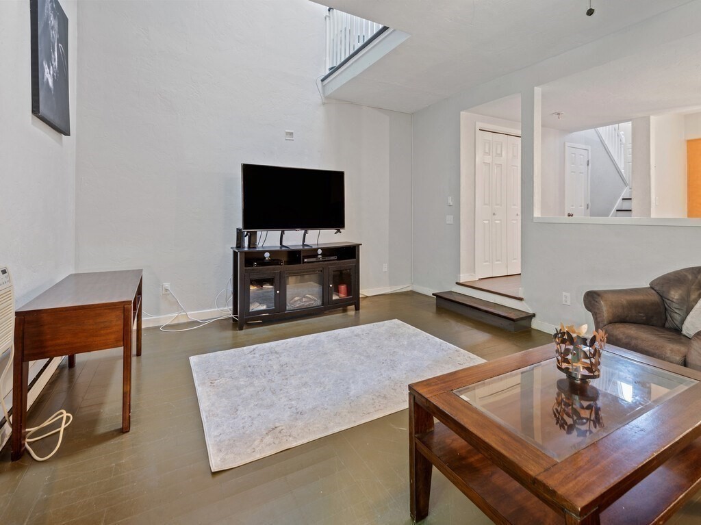 97 Riverview Place, Unit C Southbridge, MA 01550 - Photo 15 of 35 a living room with furniture and a flat screen tv