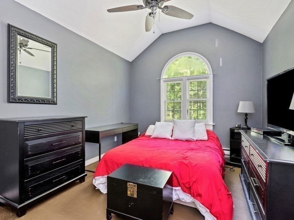 97 Riverview Place, Unit C Southbridge, MA 01550 - Photo 23 of 35 a bedroom with a bed and a chandelier