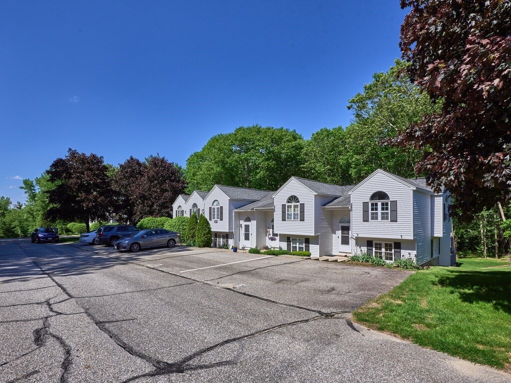 97 Riverview Place, Unit C Southbridge, MA 01550 - Photo 3 of 35 a view of a big house with a big yard and large trees