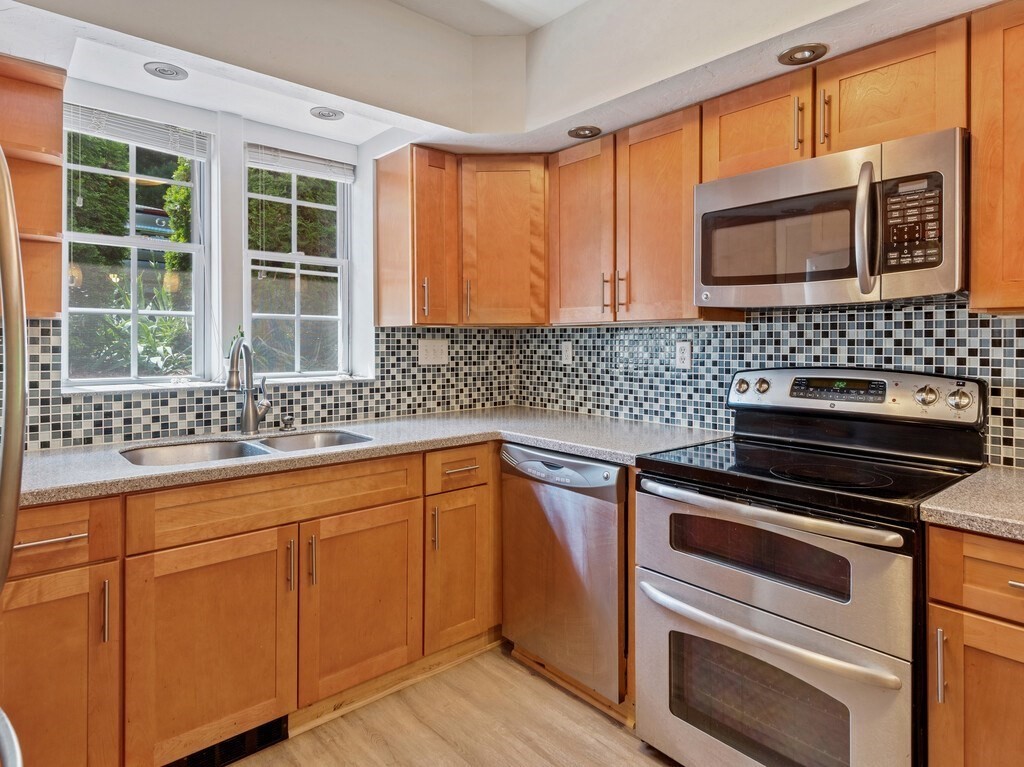 97 Riverview Place, Unit C Southbridge, MA 01550 - Photo 5 of 35 a kitchen with granite countertop cabinets stainless steel appliances and a sink