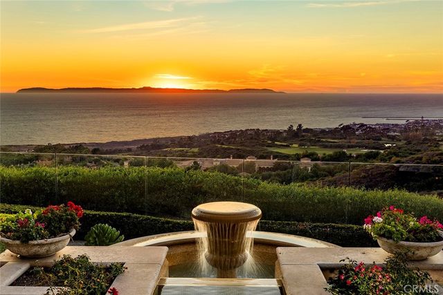 a view of a lake with a flower garden