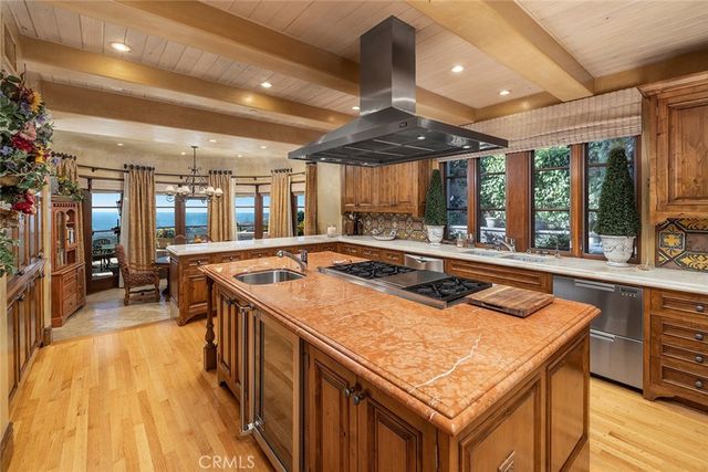 a kitchen with a stove sink and cabinets