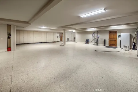 a bedroom with a large bed couch and a large window