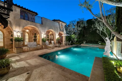 a swimming pool with outdoor seating and yard