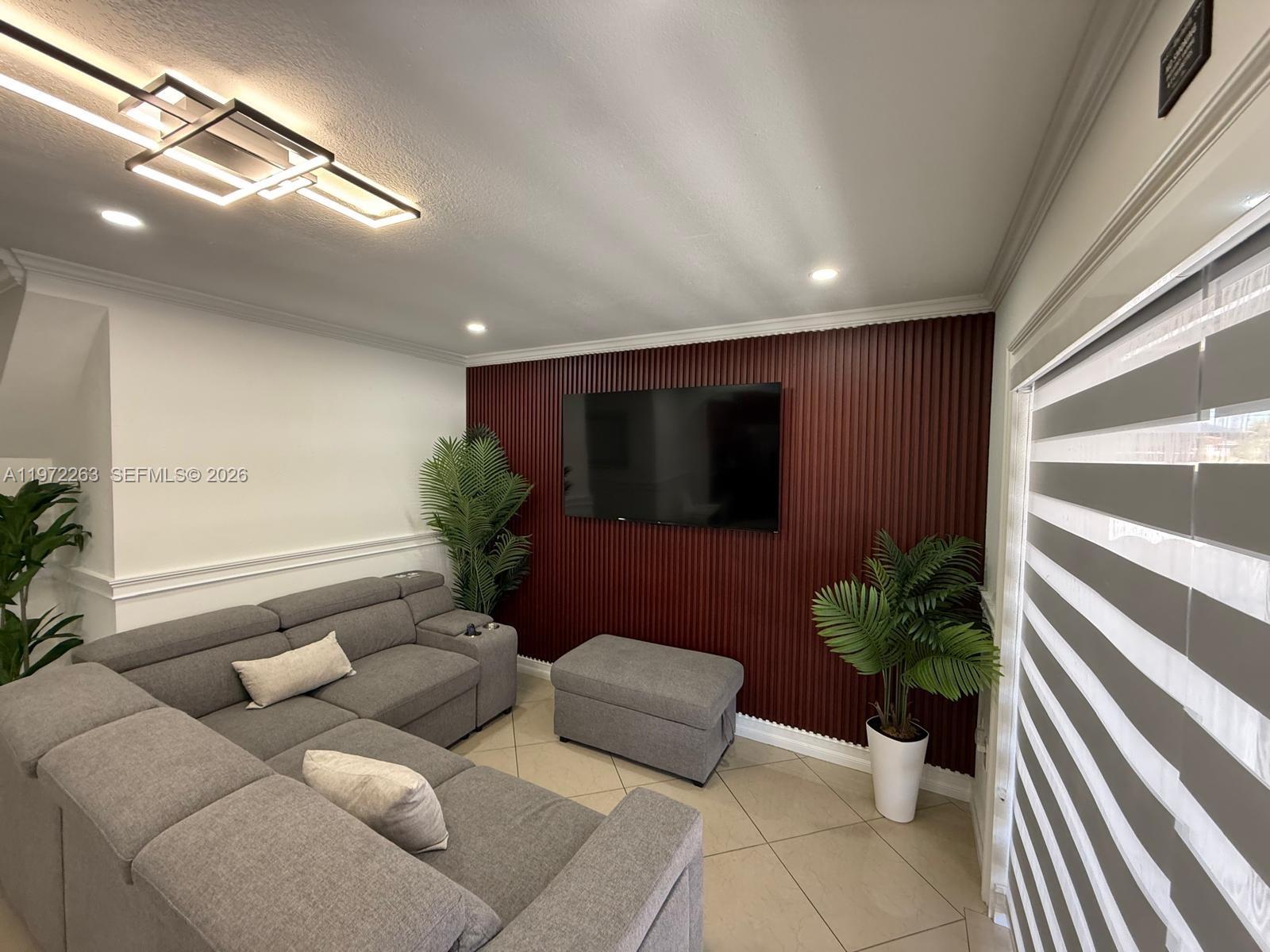 15445 Southwest 57th Street Miami, FL 33193 - Photo 16 of 78 a living room with furniture potted plant and a window