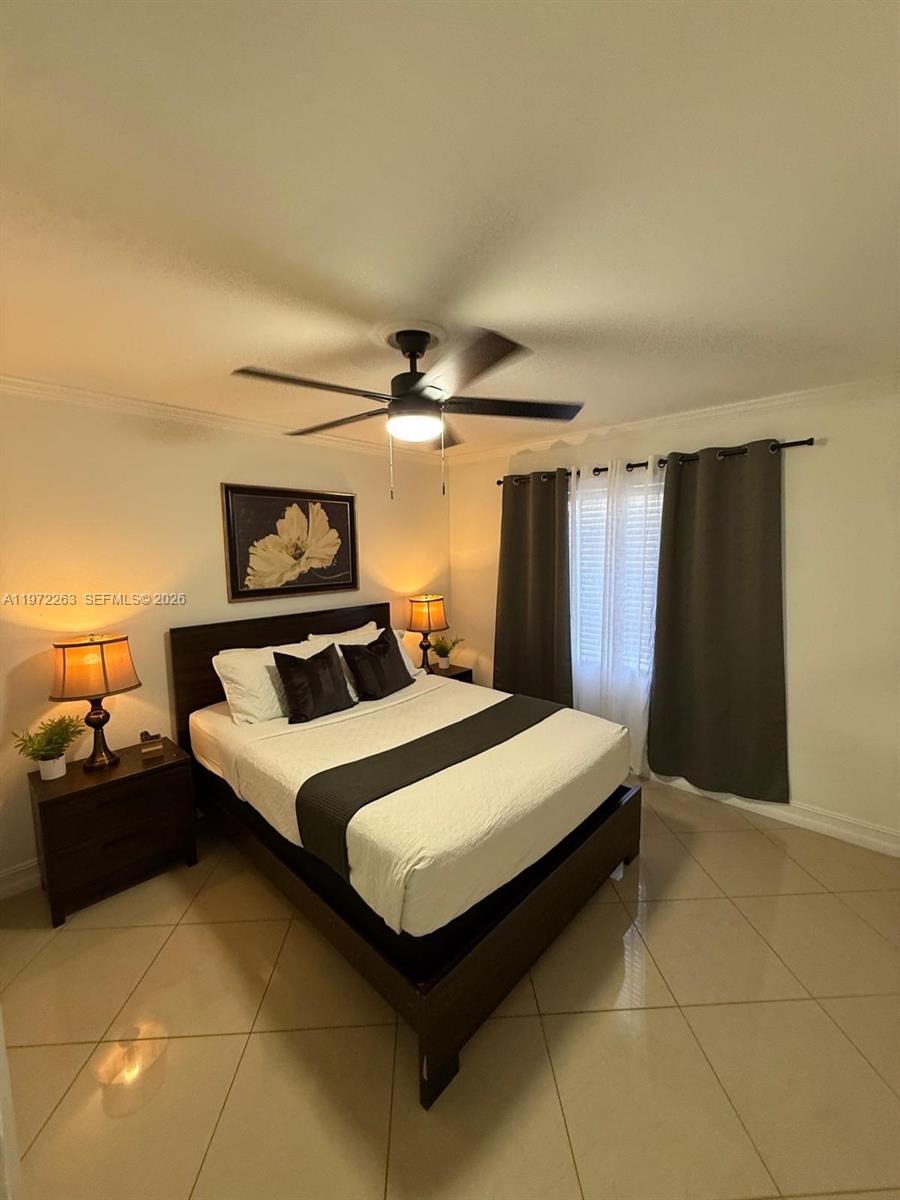 15445 Southwest 57th Street Miami, FL 33193 - Photo 25 of 78 a bedroom with a bed and a mirror