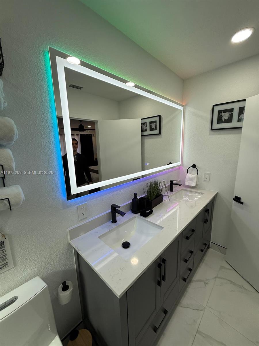15445 Southwest 57th Street Miami, FL 33193 - Photo 30 of 78 a bathroom with a sink and a mirror