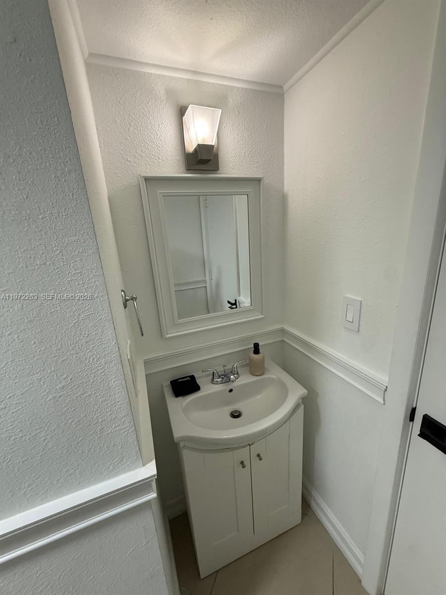 15445 Southwest 57th Street Miami, FL 33193 - Photo 31 of 78 a bathroom with a sink and a mirror