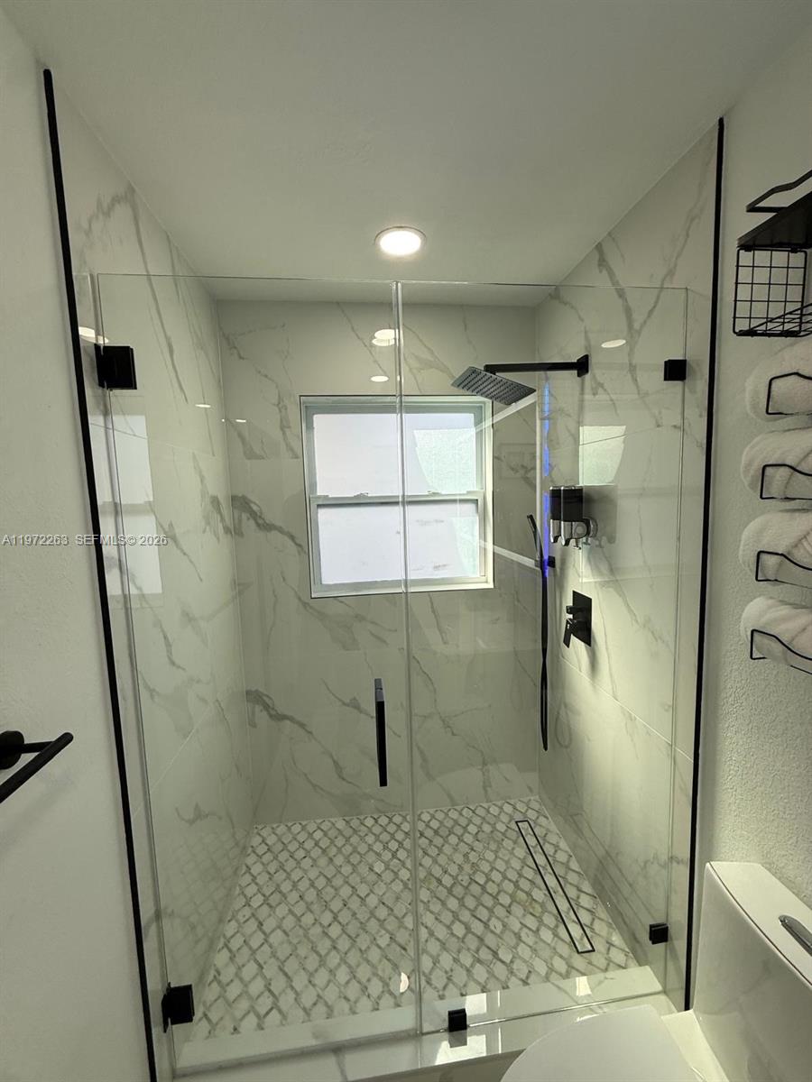 15445 Southwest 57th Street Miami, FL 33193 - Photo 32 of 78 a bathroom with a sink a toilet a mirror and shower