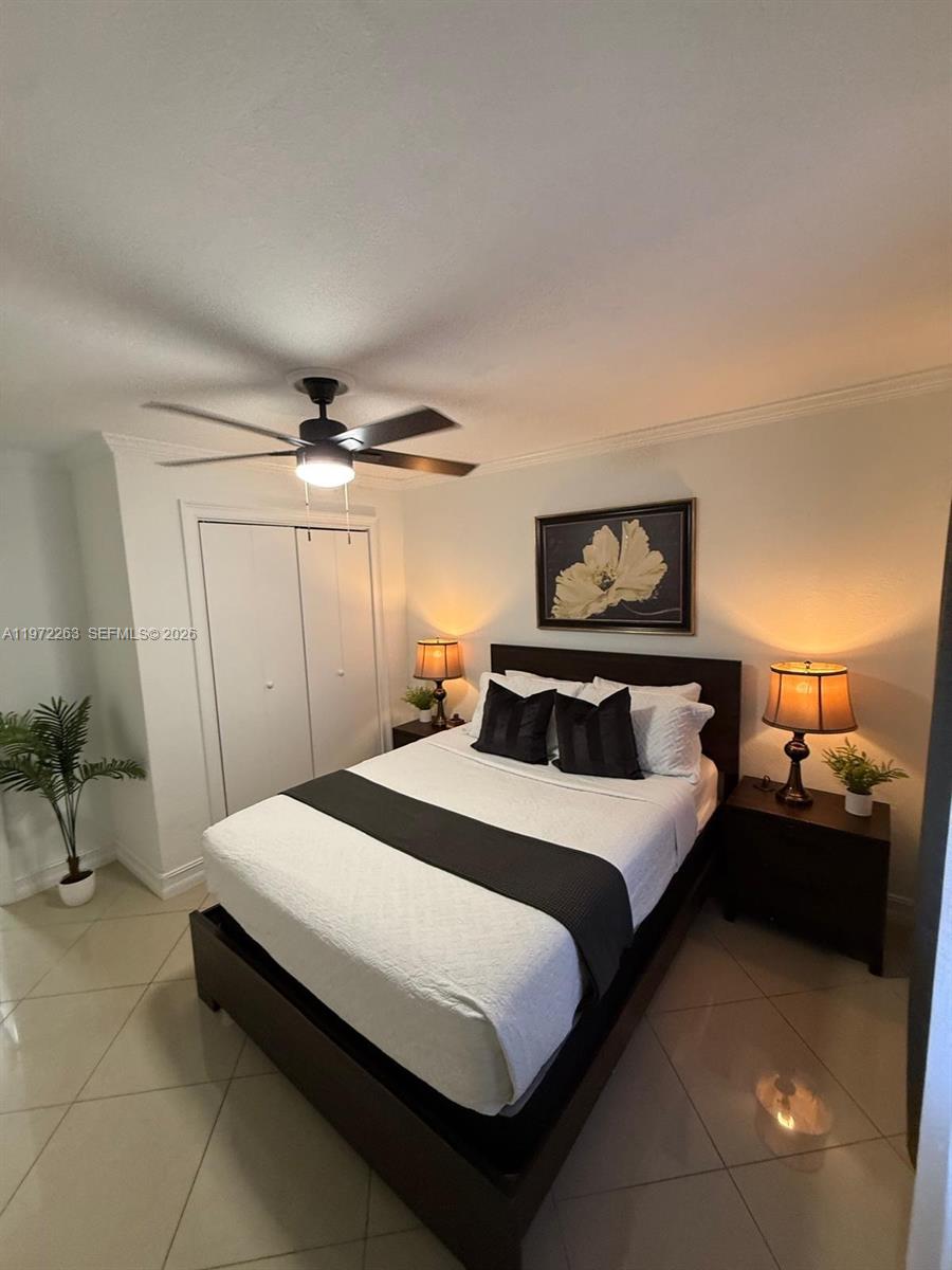 15445 Southwest 57th Street Miami, FL 33193 - Photo 36 of 78 a bedroom with a bed and a table