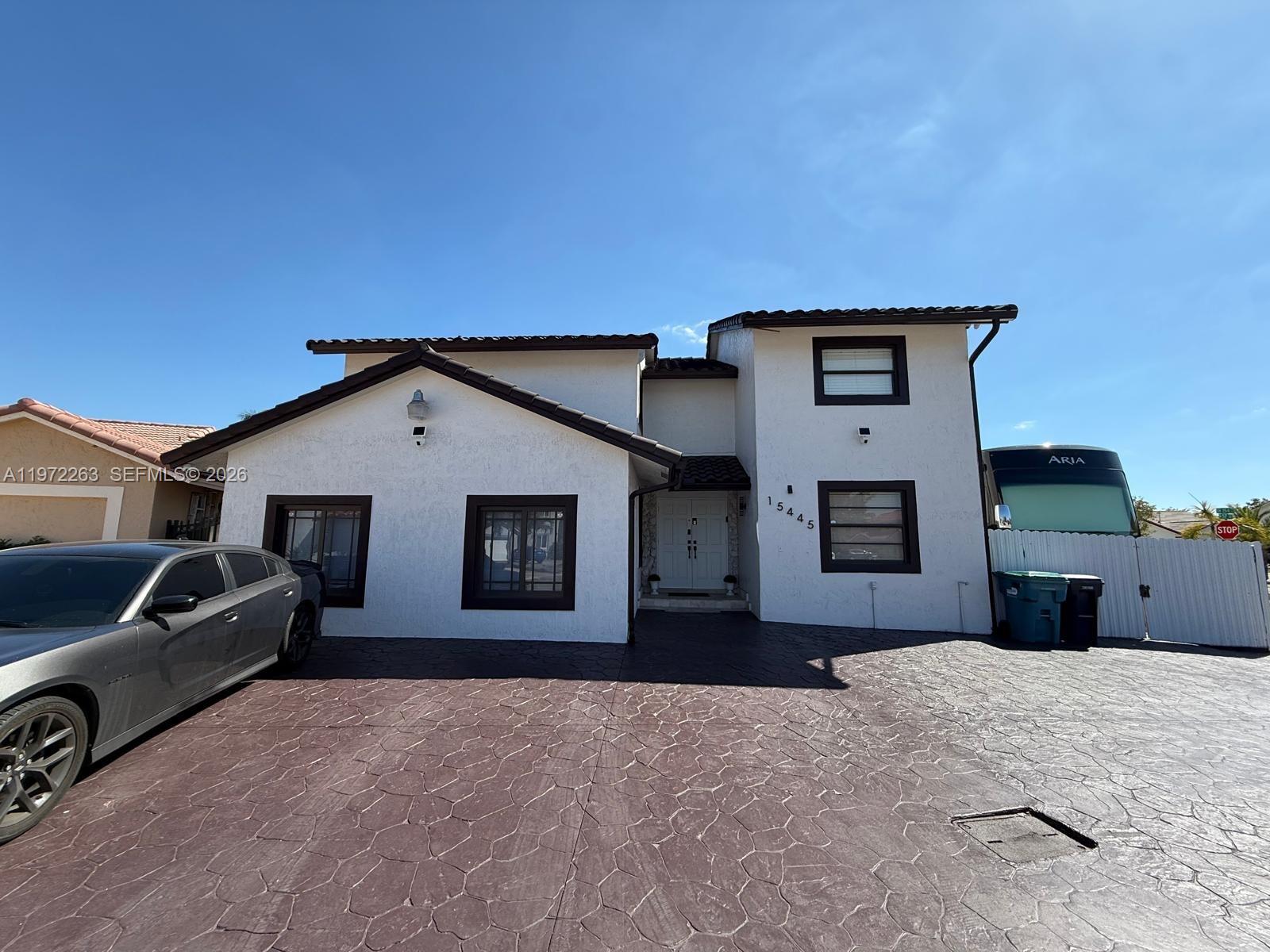 15445 Southwest 57th Street Miami, FL 33193 - Photo 4 of 78 a front view of a house with a yard