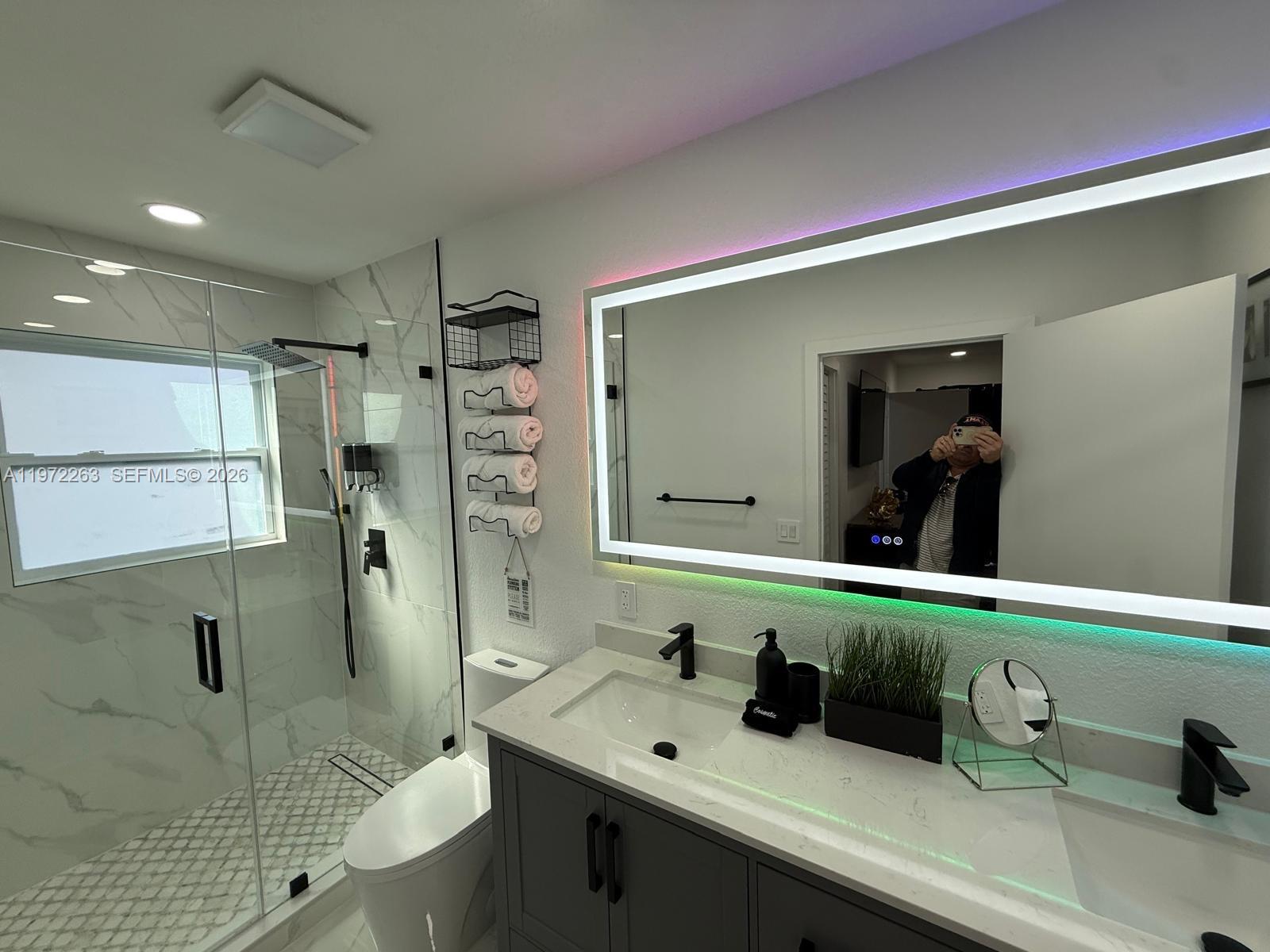 15445 Southwest 57th Street Miami, FL 33193 - Photo 43 of 78 a bathroom with a sink and a mirror