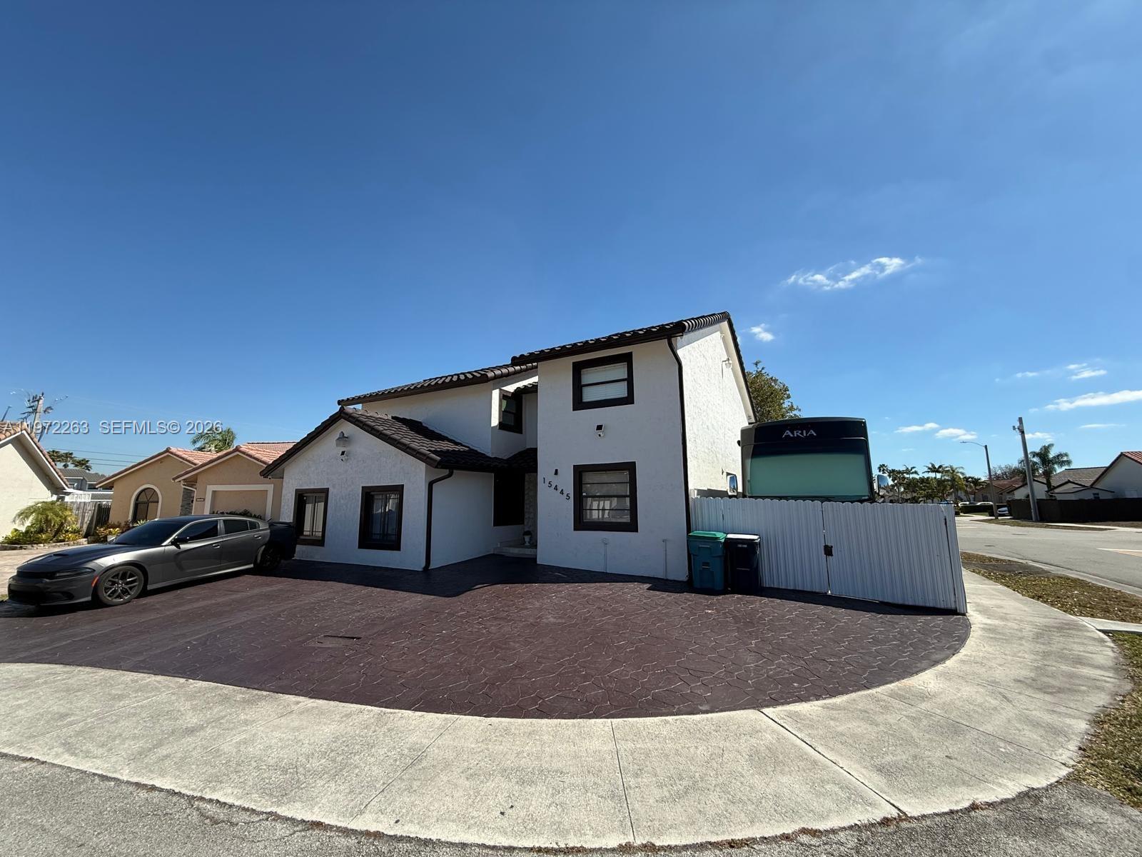 15445 Southwest 57th Street Miami, FL 33193 - Photo 5 of 78 a front view of a house with a yard and garage