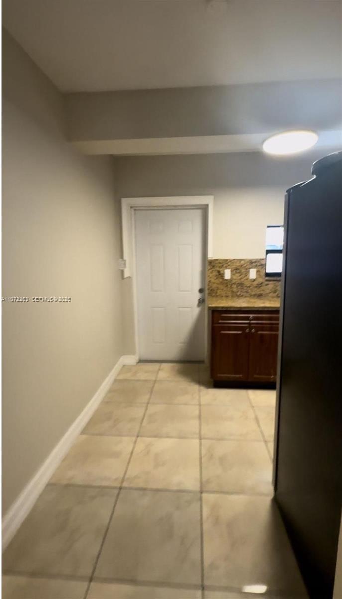 15445 Southwest 57th Street Miami, FL 33193 - Photo 52 of 78 a kitchen with granite countertop a stove and cabinets