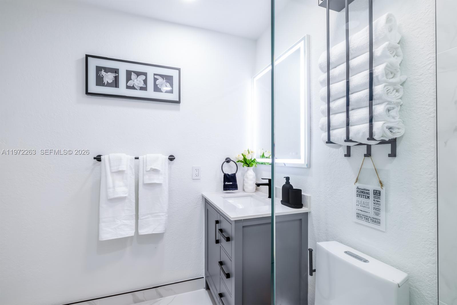 15445 Southwest 57th Street Miami, FL 33193 - Photo 59 of 78 a bathroom with a toilet sink and mirror