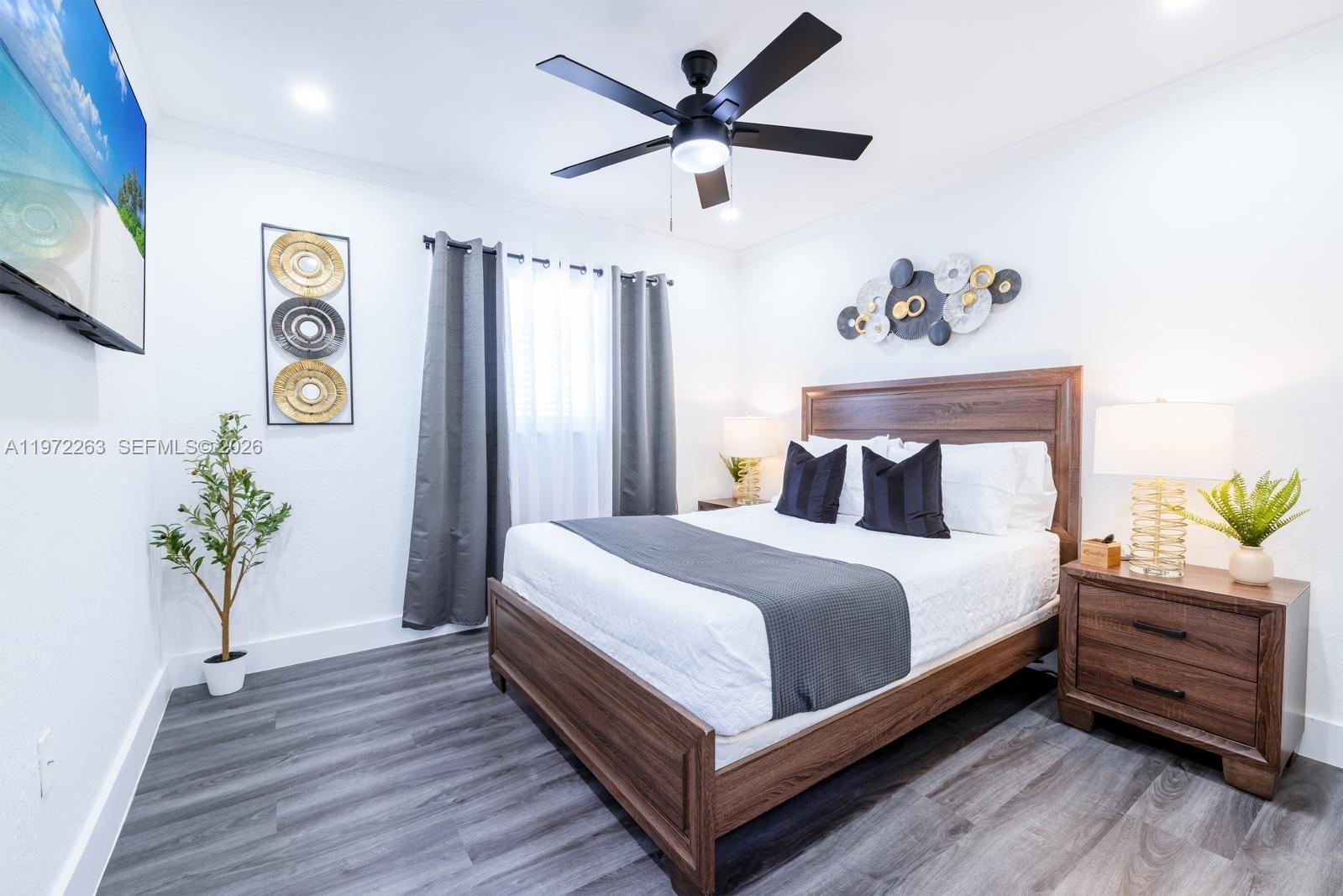 15445 Southwest 57th Street Miami, FL 33193 - Photo 61 of 78 a bedroom with bed and a chandelier