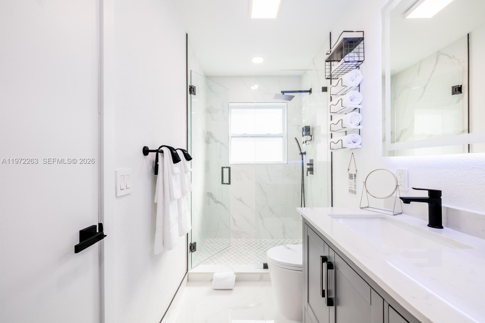 15445 Southwest 57th Street Miami, FL 33193 - Photo 69 of 78 a bathroom with a sink toilet shower and a mirror