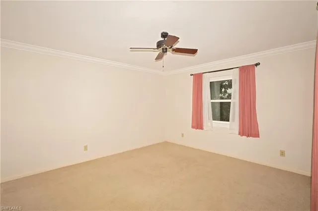 a view of empty room with ceiling fan