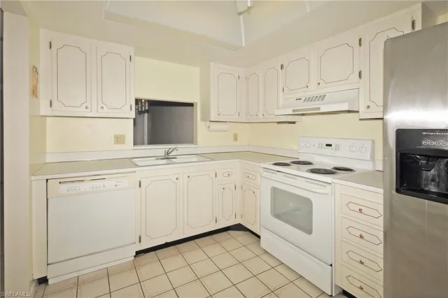 a view of a room with furniture and a window