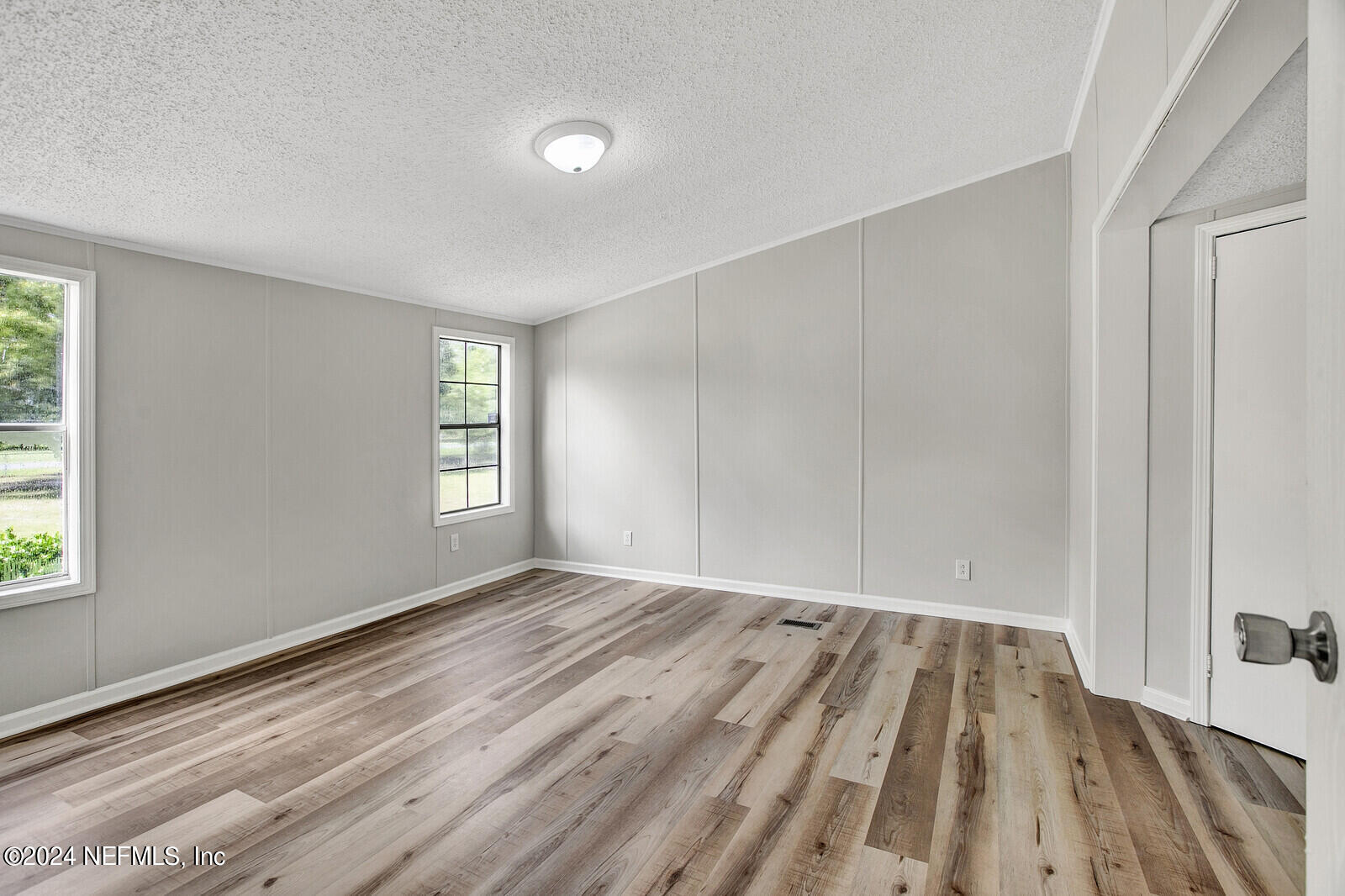 4016 Pinto Road Middleburg, FL 32068 - Photo 33 of 37 wooden floor in an empty room with a window