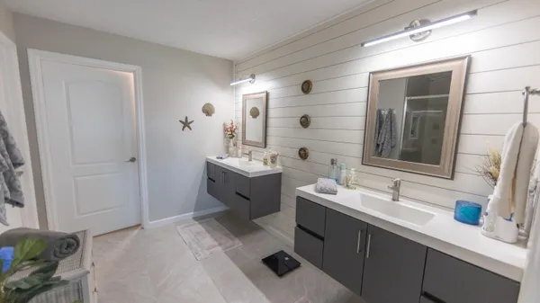 a bedroom with a bed and a flat tv screen on the dresser