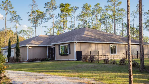 a view of a house with a yard