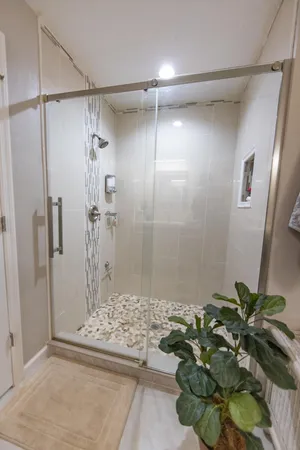 a view of a hallway with wooden floor and windows