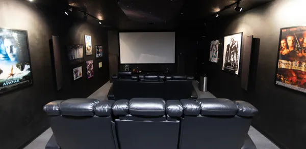 a view of a white house next to a yard with big trees