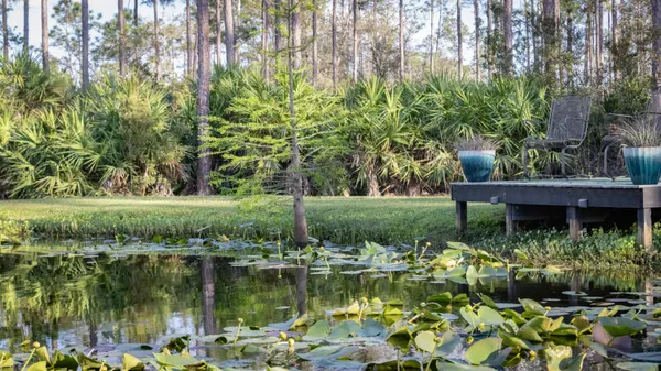 a backyard of a house with barbeque oven table and chairs