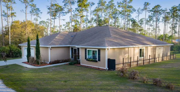 a backyard of a house with a yard and outdoor seating