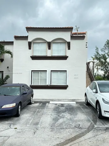a view of a car parked in front of a house