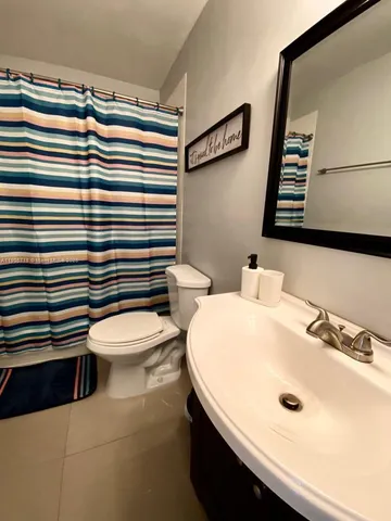 a bathroom with a sink a toilet and mirror