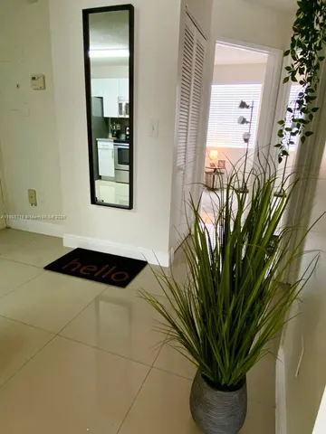 a vase of flowers sitting on a floor