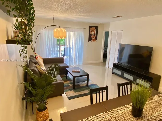 a living room with furniture fireplace and flat screen tv