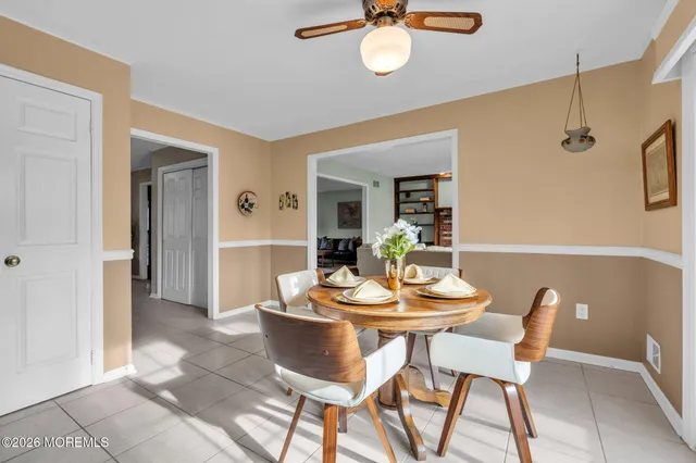 a dining room with furniture and window